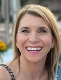 Woman with blonde hair and a smile.