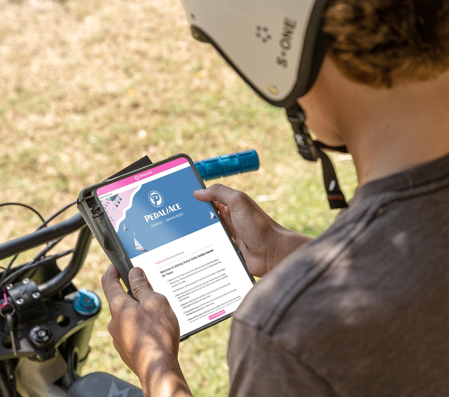 Person using a smartphone with a cycling app on a bicycle